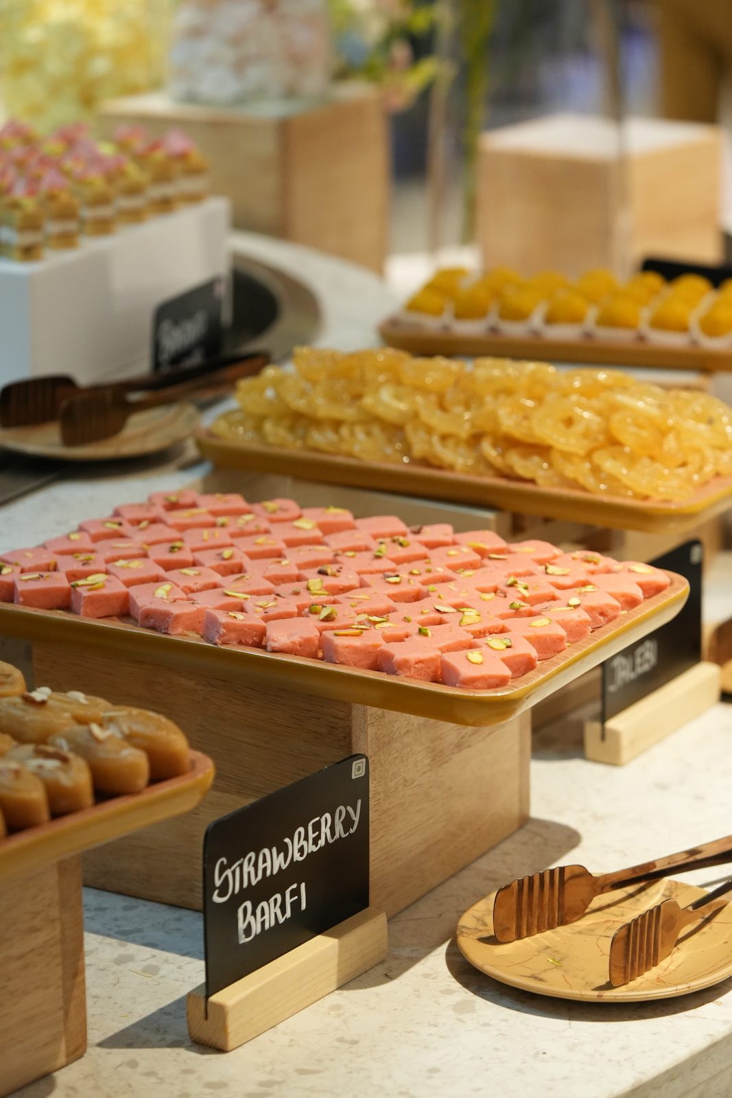 Strawberry barfi and kesar jalebi at the dessert counter